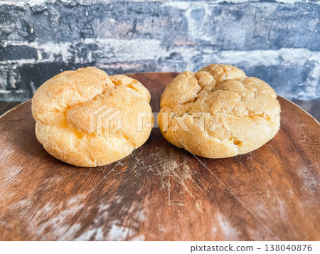 Two fluffy cream puffs on a plate. 138040876