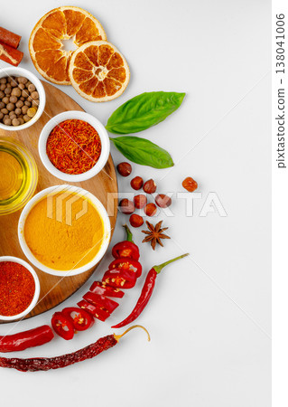 Mixing spices and herbs for cooking in a kitchen setting with bright colors and textures Mixing spices and herbs for cooking in a kitchen setting with bright colors and textures 138041006