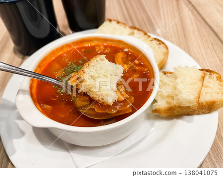 A steaming hot minestrone soup packed with vegetables, served with bread. A steaming hot minestrone soup packed with vegetables, served with bread. 138041075