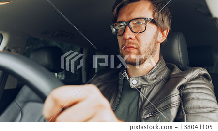 Driver focused on the road during a day trip in an urban area Driver focused on the road during a day trip in an urban area 138041105