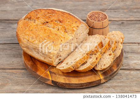 Seeded Bread Loaf with Slices on Wooden Board Seeded Bread Loaf with Slices on Wooden Board 138041473