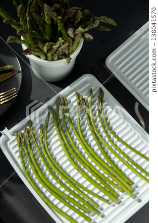 Bunch of green asparagus sprout. Fresh spring vegetable food on grill. Bunch of green asparagus sprout. Fresh spring vegetable food on grill. 138041570
