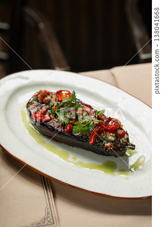 Roasted eggplant with herbs and chili on plate 138041668