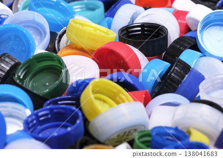 Large pile of colorful plastic bottle caps for recycling 138041683
