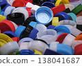 Large pile of colorful plastic bottle caps for recycling 138041687