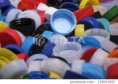 Large pile of colorful plastic bottle caps for recycling 138041687