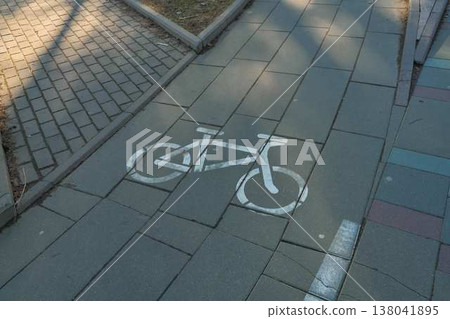 Bike Stencil On Sidewalk Directs Cyclists Along Designated Safe Pathways With Clear Signage Bike Stencil On Sidewalk Directs Cyclists Along Designated Safe Pathways With Clear Signage 138041895