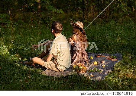 Young pair seated calmly with scenic backdrop 138041916