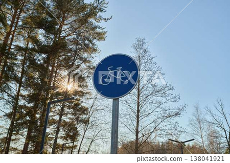 Tranquil Outdoor Landscape Featuring Circular Traffic Marker Set Against Lush Greenery And Bright Sunlight 138041921