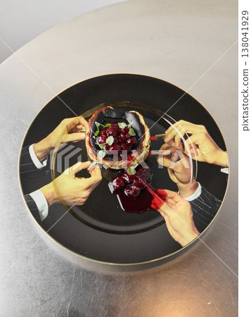 Overhead view hands sharing cherry tart with suit sleeves and syrup 138041929