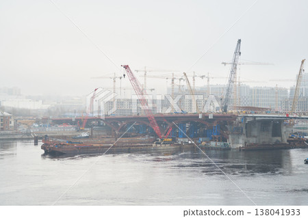 Misty river scene with engineers monitoring heavy steel installation 138041933