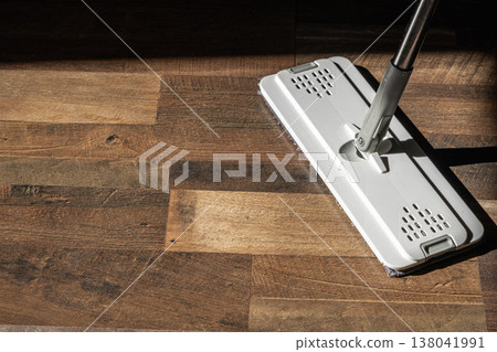 Top view of a flat microfiber mop on a wooden floor in natural light Top view of a flat microfiber mop on a wooden floor in natural light 138041991