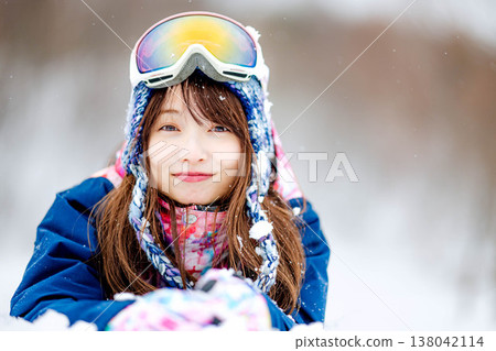 A young woman lying on the snow A young woman lying on the snow 138042114