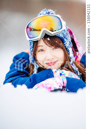 A young woman lying on the snow A young woman lying on the snow 138042131