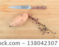 Top view of the kitchen knife and one raw sweet potato batata . 138042307