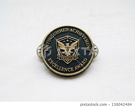 Metal award pin with eagle emblem for distinguished achievement and excellence with white background 138042484
