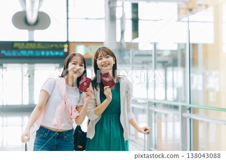 Two women holding passports at the airport. (Photography courtesy of Kansai International Airport (KIX)) Two women holding passports at the airport. (Photography courtesy of Kansai International Airport (KIX)) 138043088