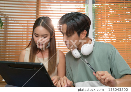A young Asian couple spend time together at home A young Asian couple spend time together at home 138043200