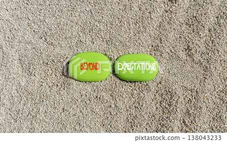 Beyond expectations words symbol. Concept words Beyond expectations on beautiful green stones. Beautiful sand background. Business and Beyond expectations words concept. Copy space. 138043233