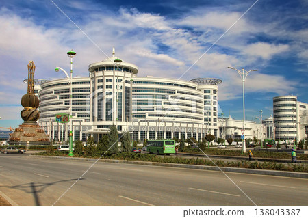 Ashgabat, Turkmenistan - October 20, 2023: View of the Sport Hotel and the art monument. Ashgabat, Turkmenistan - October 20, 2023: View of the Sport Hotel and the art monument. 138043387