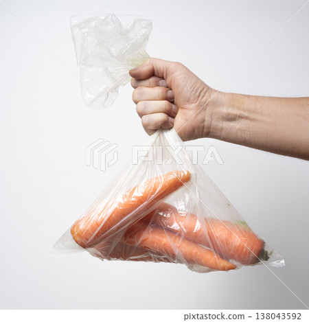 a plastic bag with some carrots a plastic bag with some carrots 138043592