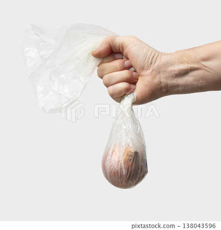 a plastic bag with an onion a plastic bag with an onion 138043596