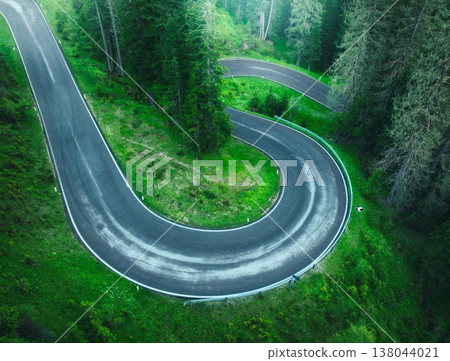 Aerial view of wet curvy road and green forest in summer Aerial view of wet curvy road and green forest in summer 138044021