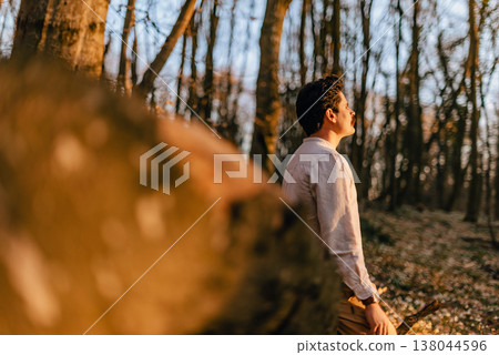 Man Reconnecting with Himself in Spring Forest at Sunset Man Reconnecting with Himself in Spring Forest at Sunset 138044596