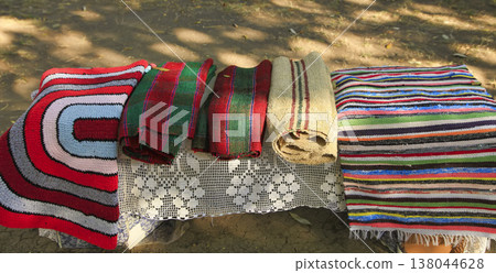 Homemade colorful woven rugs made of cotton threads. 138044628