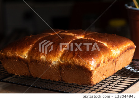 Freshly baked bread cooling on a wire rack Freshly baked bread cooling on a wire rack 138044943