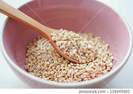 Close-up of pearl barley against a white background. Close-up of pearl barley against a white background. 138045002