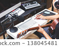 male musician writing a hit song by acoustic guitar in home studio 138045481