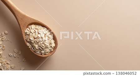 Wooden spoon with dry rolled oats 138046052