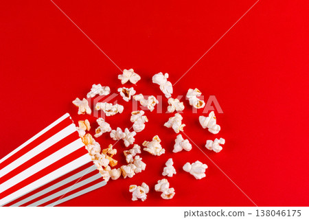 box with popcorn striped in different colors on a red background box with popcorn striped in different colors on a red background 138046175