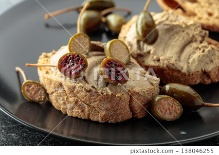 Bread with liver pate and capers. 138046255