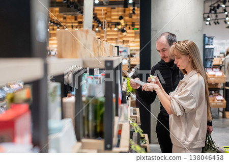A Caucasian couple shopping at a cosmetics store. A Caucasian couple shopping at a cosmetics store. 138046458