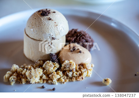 Espresso parfait served on a white plate with a crumb topping, mocha mousse, and chocolate crumble, offering a delightful and gourmet culinary experience Espresso parfait served on a white plate with a crumb topping, mocha mousse, and chocolate crumble, offering a delightful and gourmet culinary experience 138047237