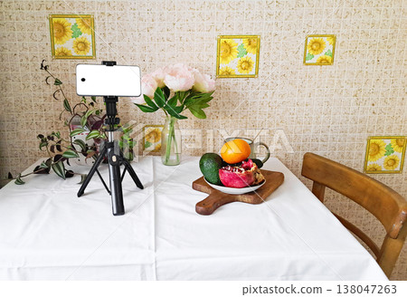 Content creation setup with smartphone, flowers, and fruits, lifestyle photography scene 138047263