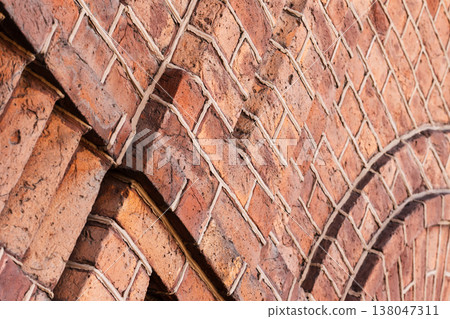 Close-up of a weathered red brick wall, abstract photo 138047311