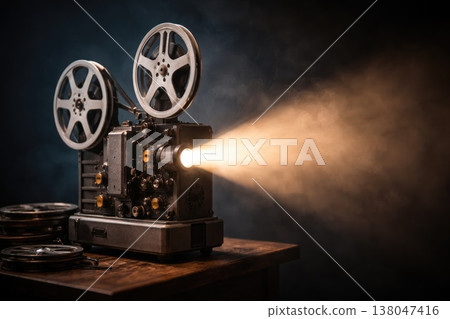 Vintage film projector casting light beam in dark cinematic atmosphere Vintage film projector casting light beam in dark cinematic atmosphere 138047416
