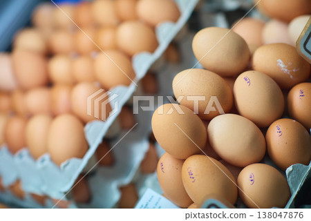 Fresh brown eggs in trays at a market packed in cartons for sale and cooking 138047876