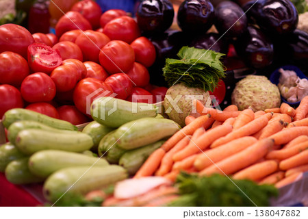 Fresh market vegetables with ripe tomatoes and carrots in colorful farmers market display 138047882