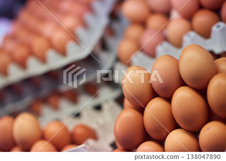 Stack of fresh brown eggs in trays at a market or farm stand, close-up food still life Stack of fresh brown eggs in trays at a market or farm stand, close-up food still life 138047890