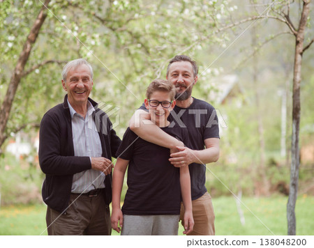 Three-generation family portrait of grandfather, father and grandson smiling together outdoors 138048200