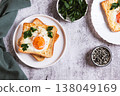 An egg baked in pieces of bread on a plate on the table top view 138049169
