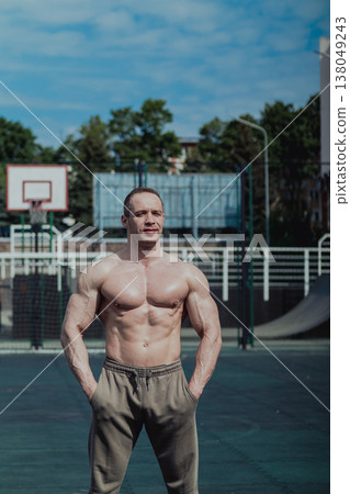 A CrossFit man poses for the camera on a sports A CrossFit man poses for the camera on a sports 138049243