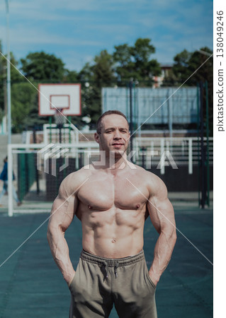 A CrossFit man poses for the camera on a sports A CrossFit man poses for the camera on a sports 138049246