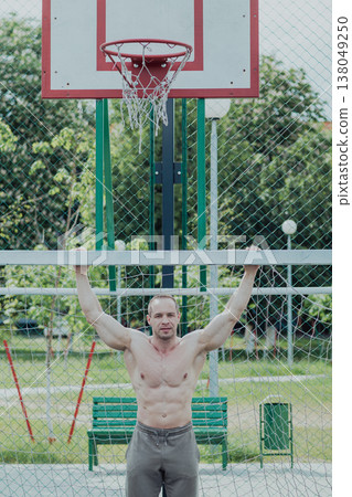 A CrossFit man poses for the camera on a sports A CrossFit man poses for the camera on a sports 138049250