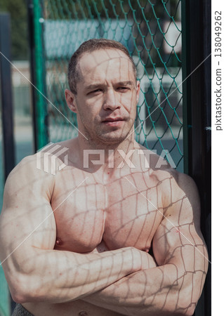 A CrossFit man poses for the camera on a sports A CrossFit man poses for the camera on a sports 138049262