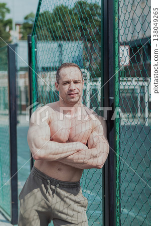 A CrossFit man poses for the camera on a sports A CrossFit man poses for the camera on a sports 138049265